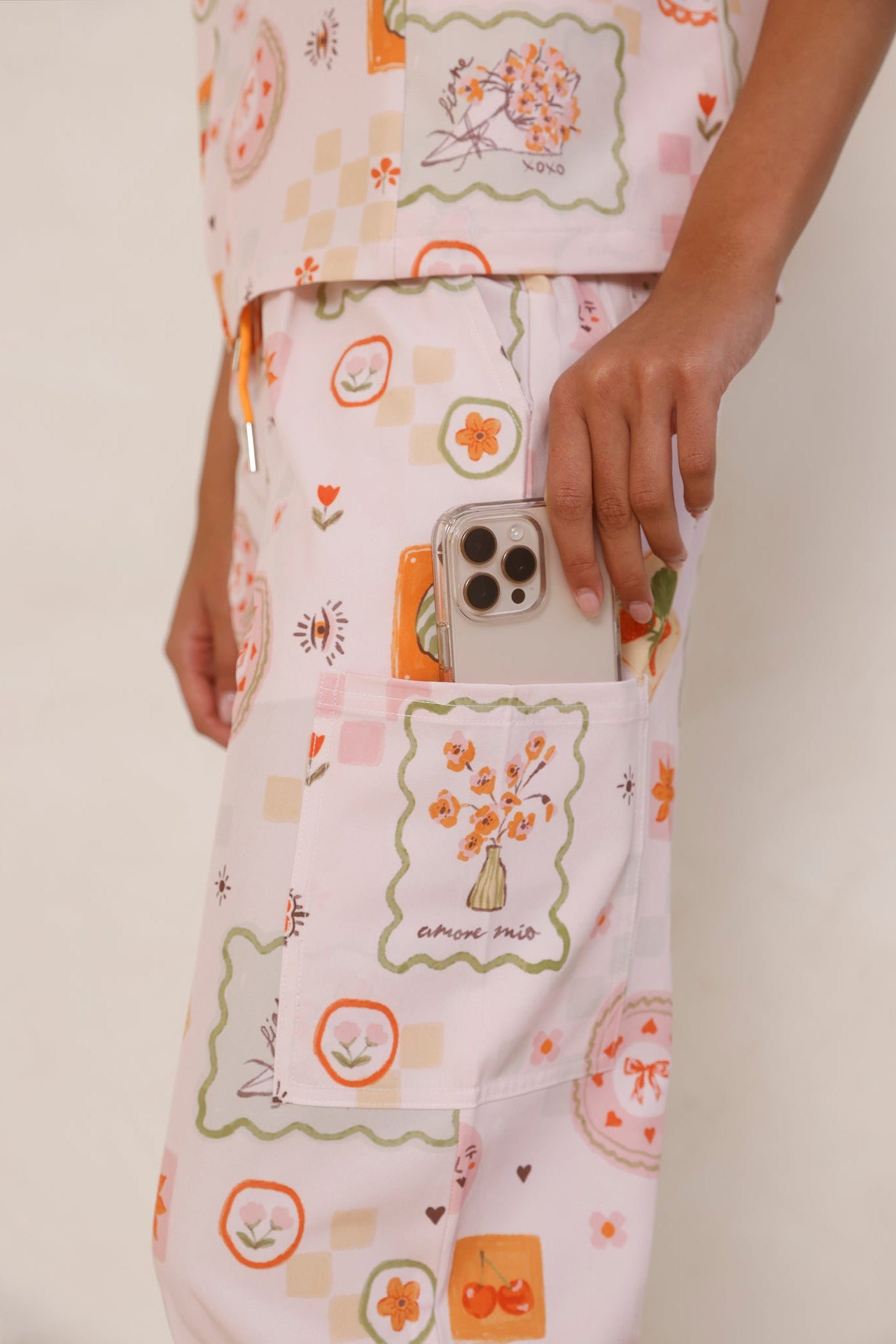 Close-up of Tuscany Women’s Performance Scrub Pants pocket holding an iPhone, showing functional design and stretch fabric