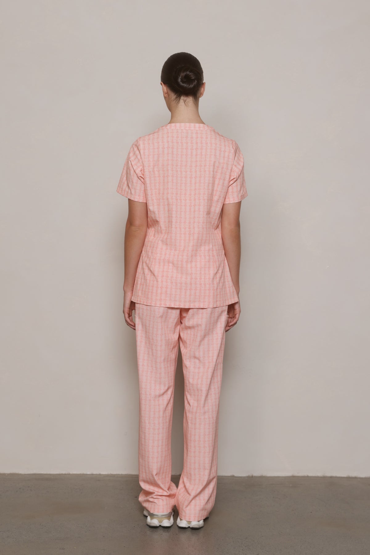 Back view of the Hero Scrubs Peach Relaxed Back scrub set, showing the relaxed top and matching pants.