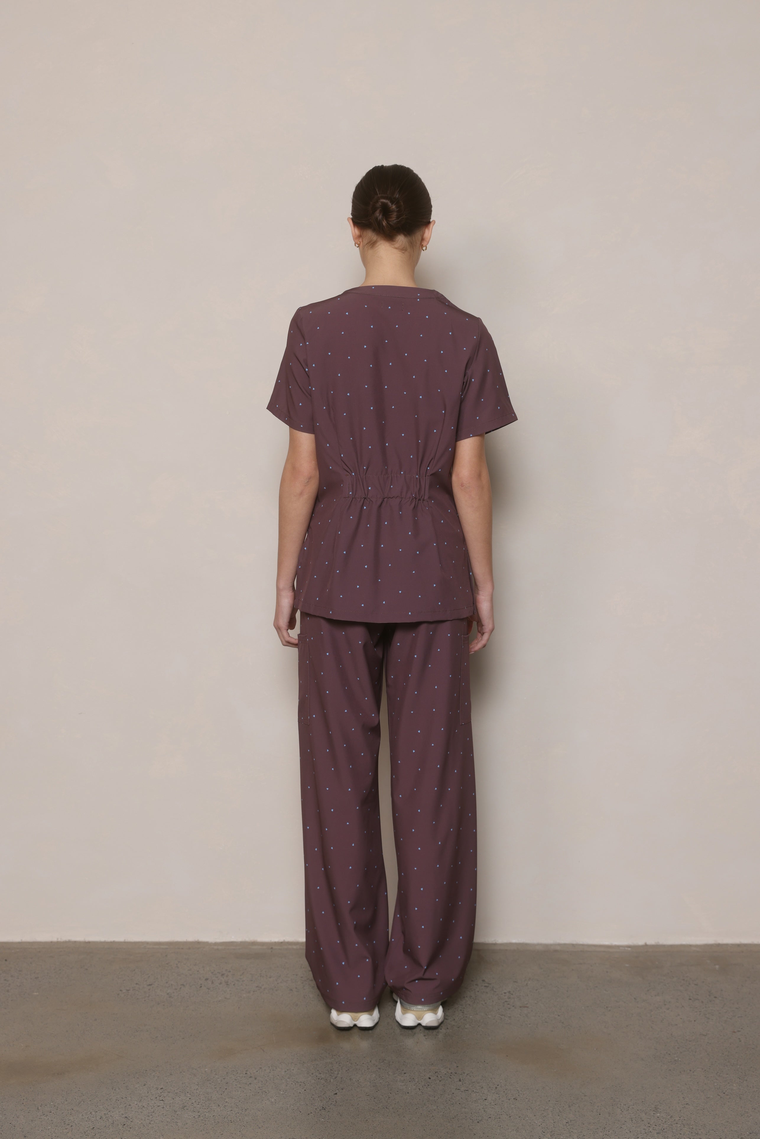 Cocoa Hearts women’s scrub set back in chocolate brown with blue micro hearts