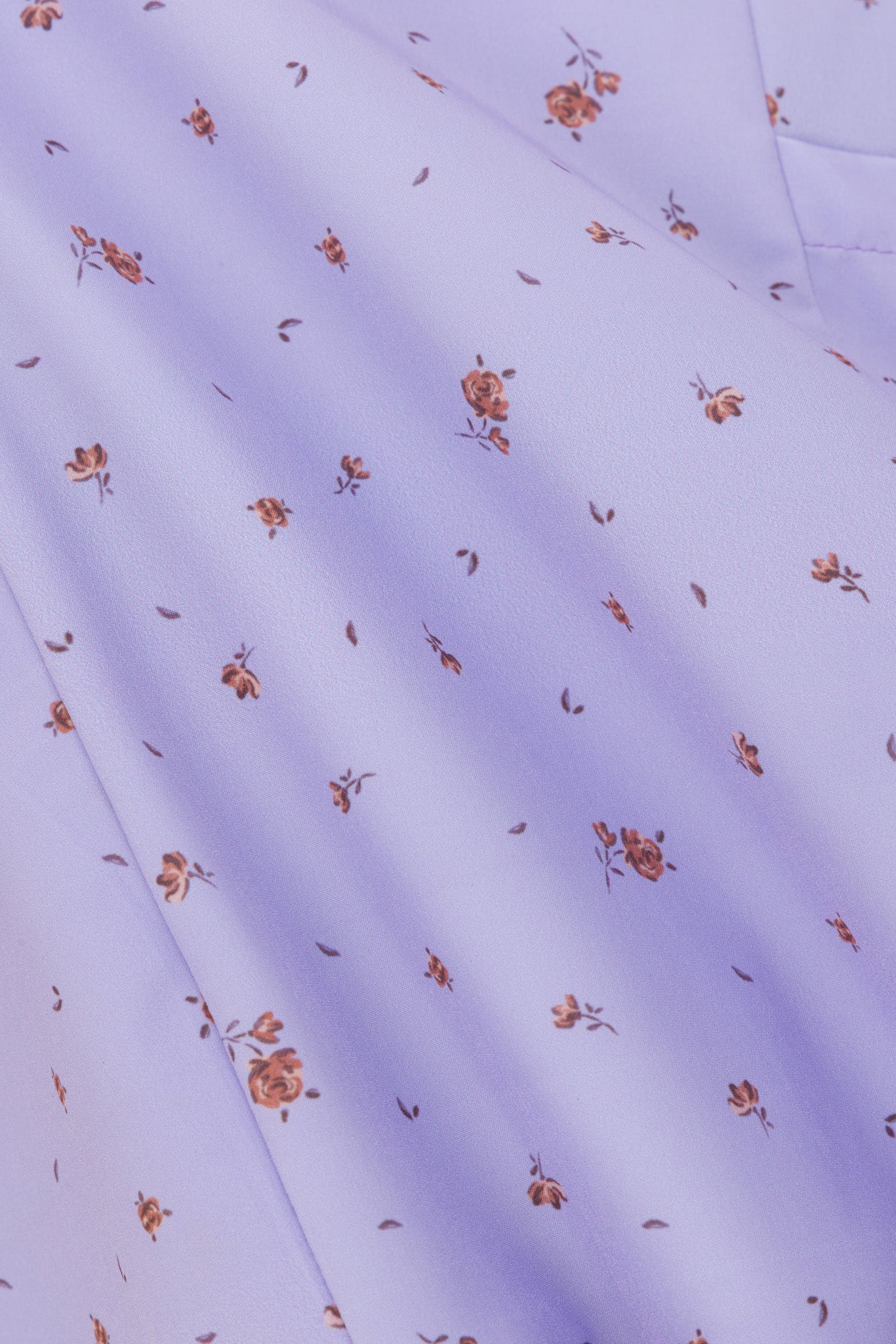 Close-up of Hero Scrubs lilac scrub fabric showing the small printed design